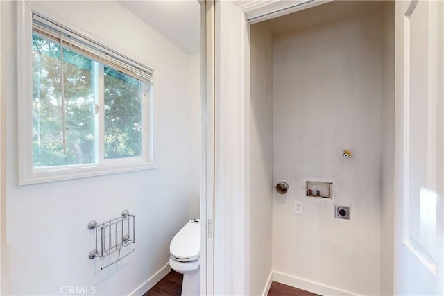 bathroom with hardwood / wood-style floors and toilet