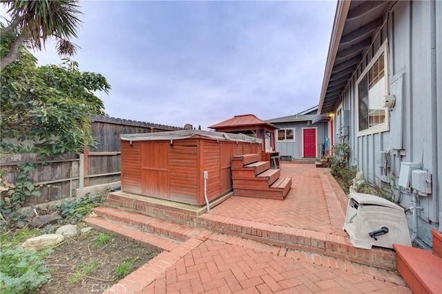 view of patio featuring a gazebo and a shed