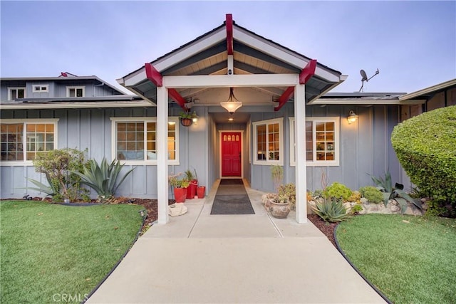 view of front of property with a front yard and solar panels