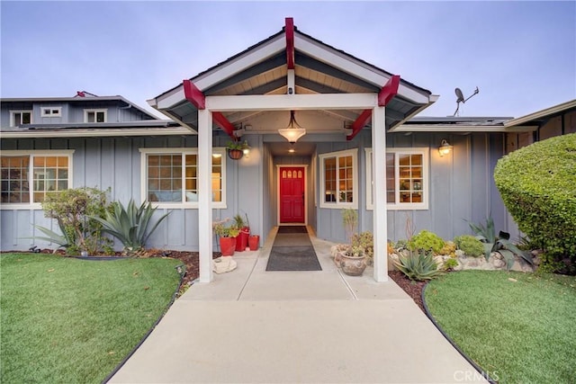 view of front of property with a front lawn and solar panels