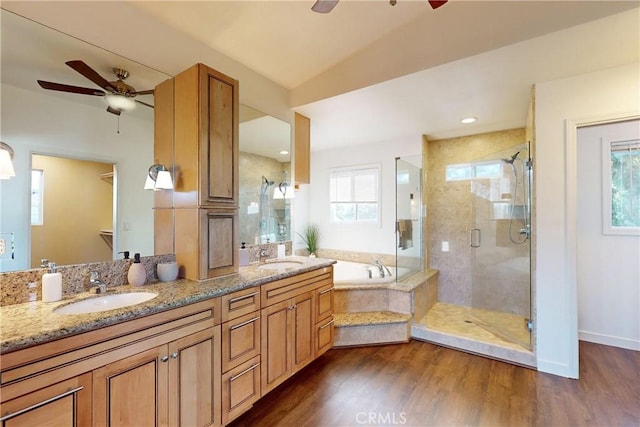 bathroom with hardwood / wood-style floors, independent shower and bath, and ceiling fan