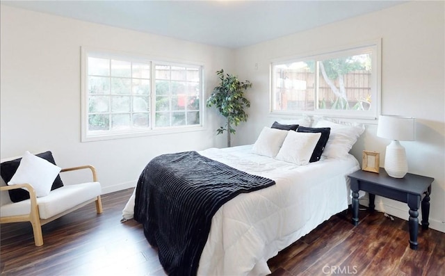 bedroom with dark wood-type flooring