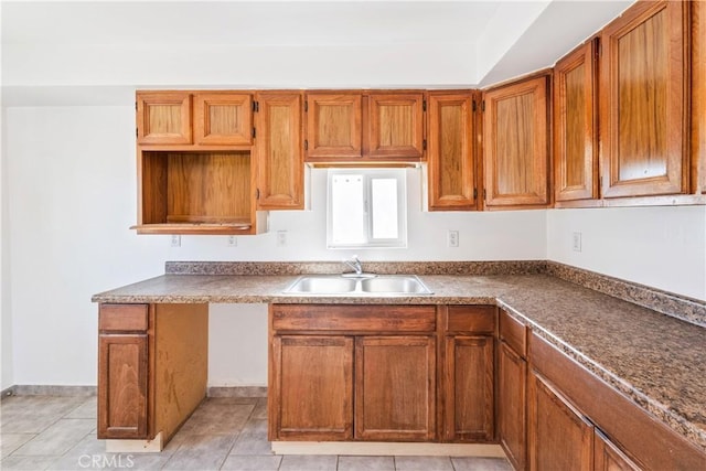 kitchen with light tile patterned floors and sink