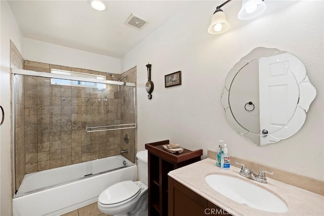 full bathroom featuring tile patterned flooring, toilet, combined bath / shower with glass door, and vanity