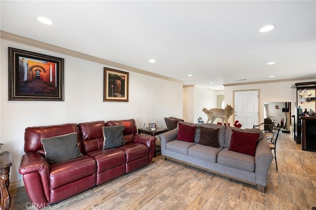 living room with light hardwood / wood-style floors and crown molding