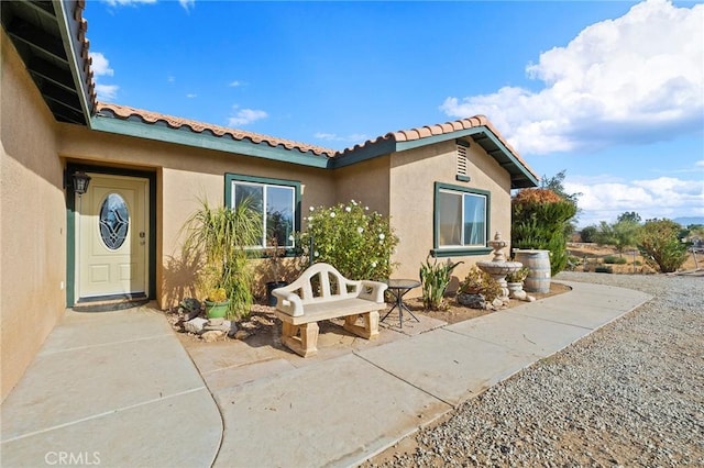 doorway to property with a patio area