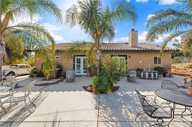 back of property with french doors and a patio area