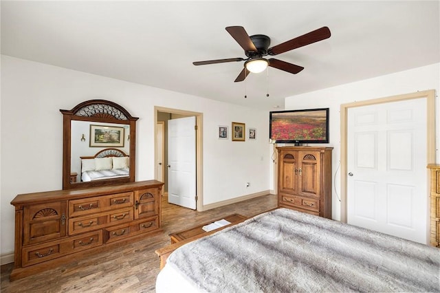 bedroom featuring ceiling fan and light hardwood / wood-style flooring