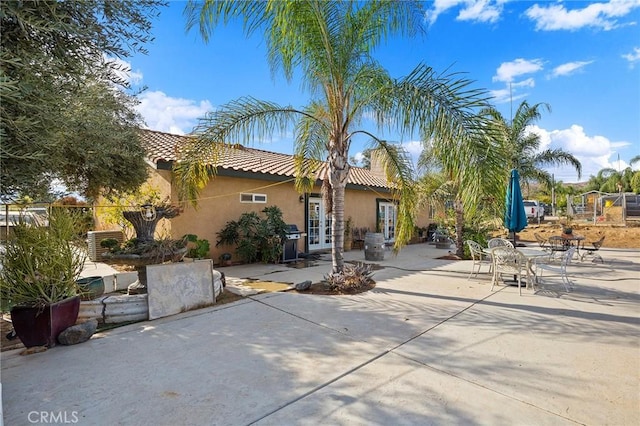 back of house featuring a patio area and french doors