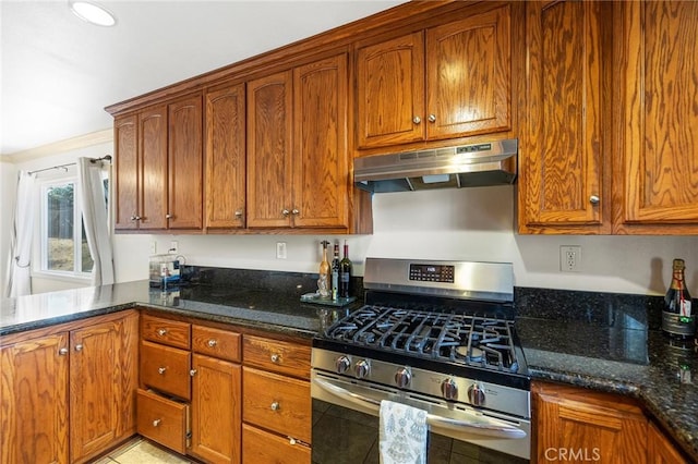 kitchen with dark stone countertops and stainless steel gas range