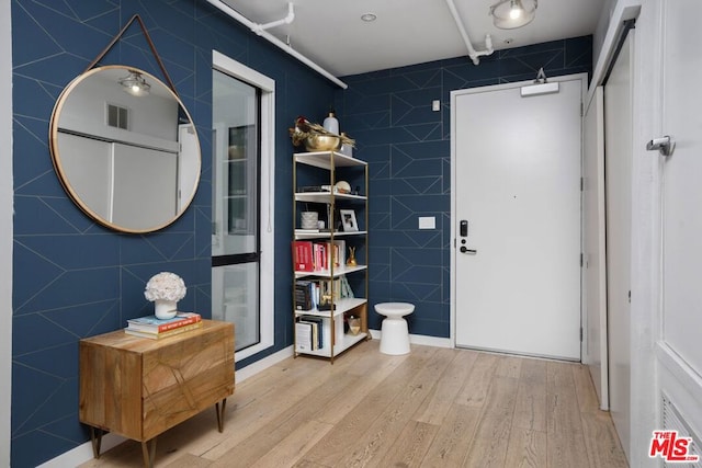 bathroom with tile walls and hardwood / wood-style flooring