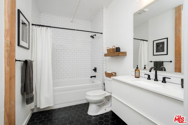 full bathroom with tile patterned floors, vanity, toilet, and shower / bath combo with shower curtain