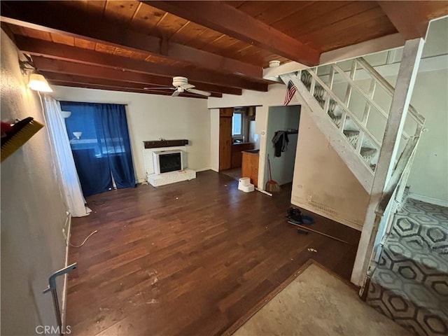 living room with beam ceiling, dark hardwood / wood-style flooring, ceiling fan, and wood ceiling