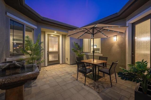 view of patio terrace at dusk