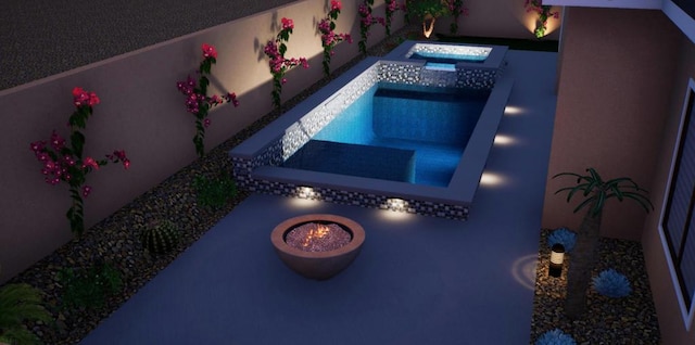 view of swimming pool with an in ground hot tub