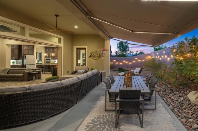 patio terrace at dusk featuring outdoor lounge area