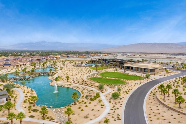 birds eye view of property with a water and mountain view