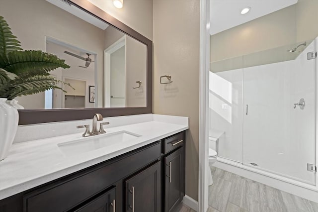 bathroom with vanity, toilet, and an enclosed shower