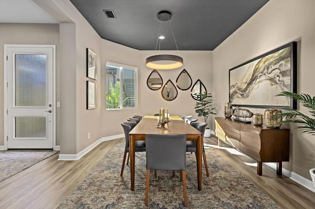 dining space with hardwood / wood-style floors