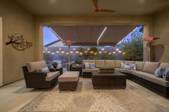 patio terrace at dusk featuring an outdoor hangout area and ceiling fan