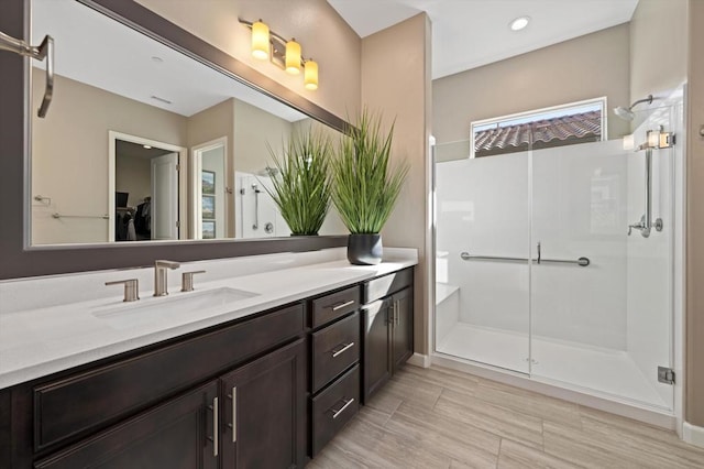 bathroom with an enclosed shower and vanity