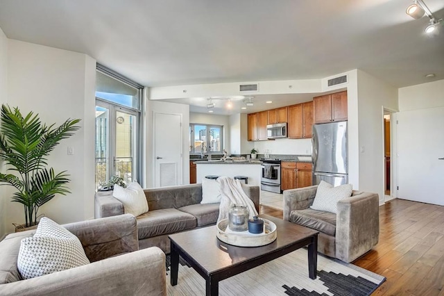 living room featuring light hardwood / wood-style floors and sink