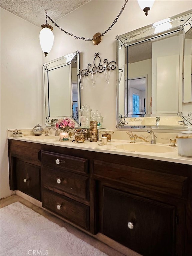 bathroom with vanity and a textured ceiling