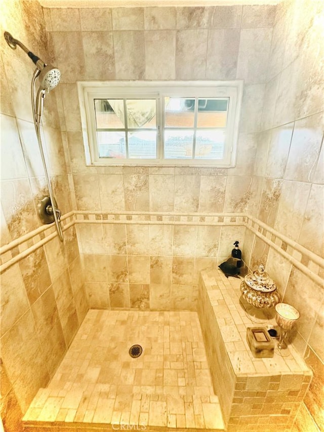 bathroom with tiled shower