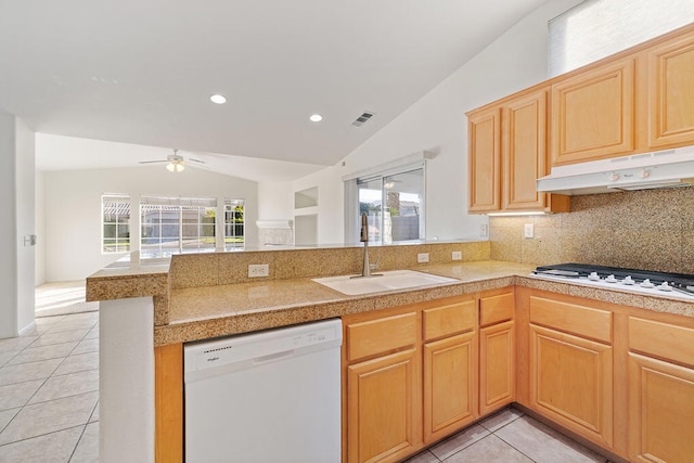 kitchen featuring white appliances, sink, vaulted ceiling, kitchen peninsula, and extractor fan