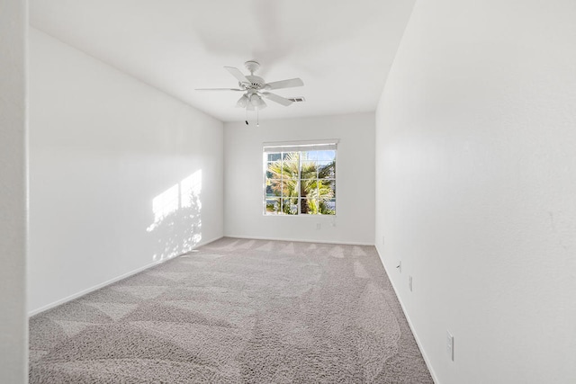 unfurnished room with ceiling fan and light carpet