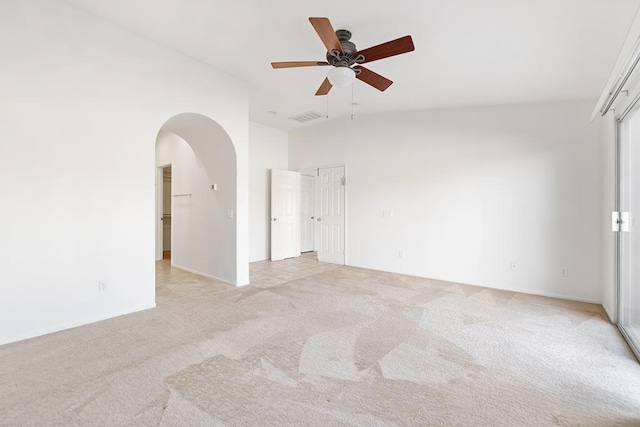 spare room with ceiling fan and light carpet