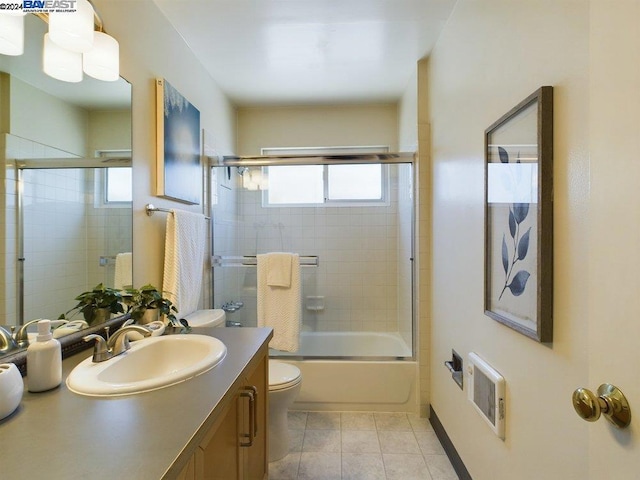 full bathroom with toilet, vanity, and shower / bath combination with glass door