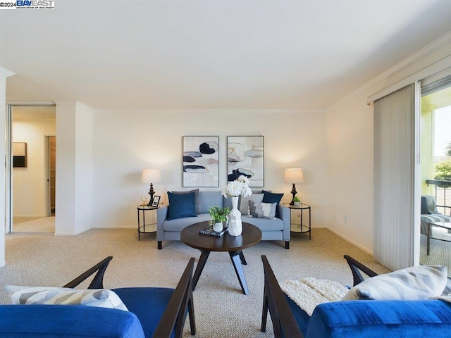 carpeted living room with crown molding