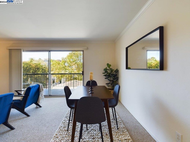 dining room with carpet floors and ornamental molding