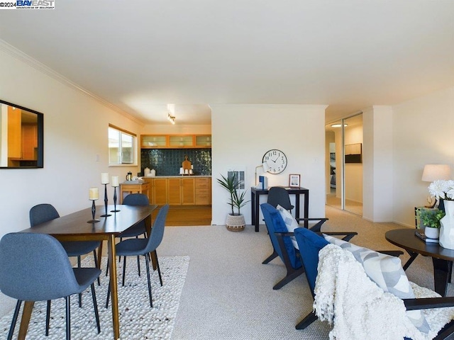 carpeted dining area featuring ornamental molding