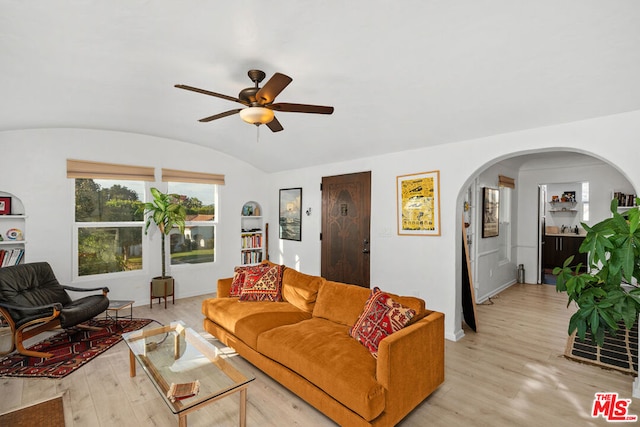 living room with ceiling fan, light hardwood / wood-style flooring, and lofted ceiling