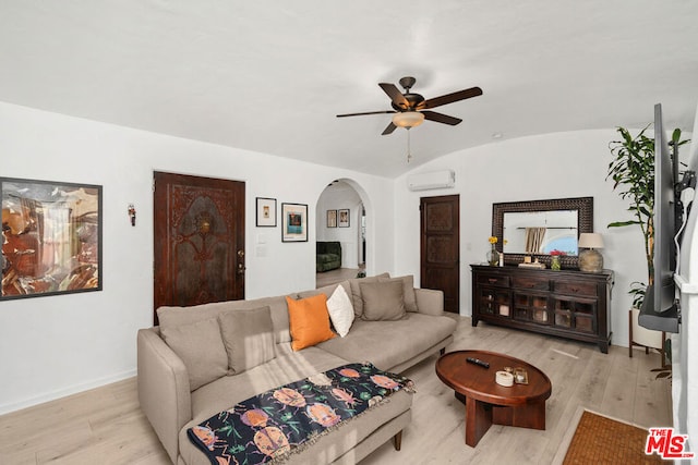 living room featuring a wall mounted AC, ceiling fan, lofted ceiling, and light wood-type flooring