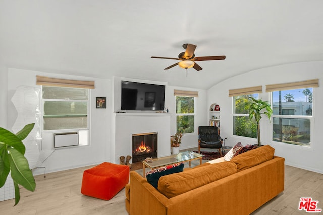 living room with ceiling fan, light hardwood / wood-style floors, and lofted ceiling