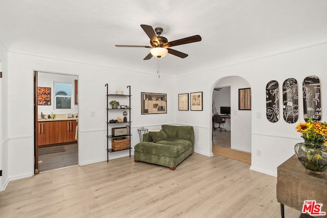 sitting room with light wood-type flooring and ceiling fan