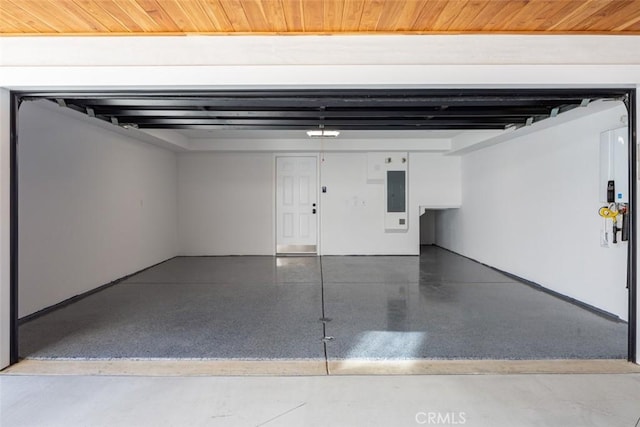 garage featuring electric panel and wooden ceiling