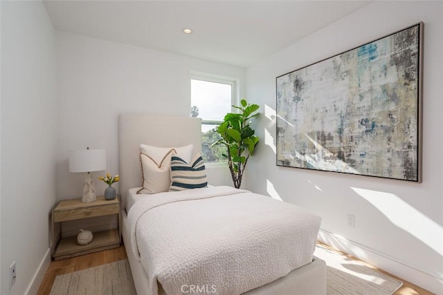 bedroom with wood-type flooring