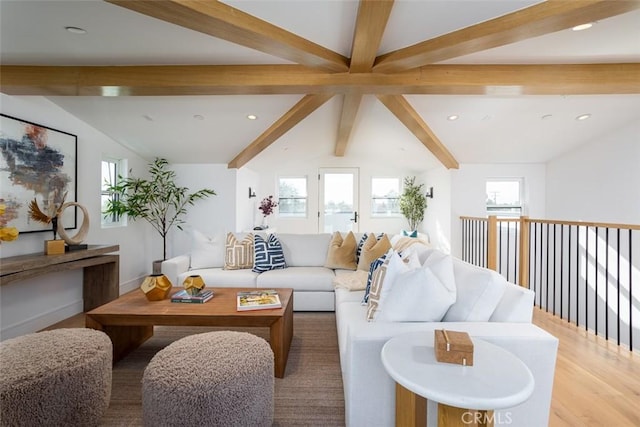 living room featuring wood-type flooring and vaulted ceiling with beams