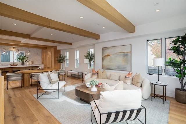 living room with beam ceiling and light hardwood / wood-style flooring