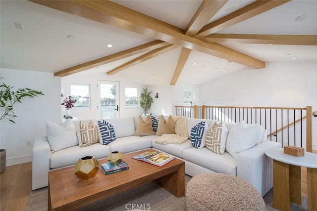 living room featuring hardwood / wood-style floors and vaulted ceiling with beams