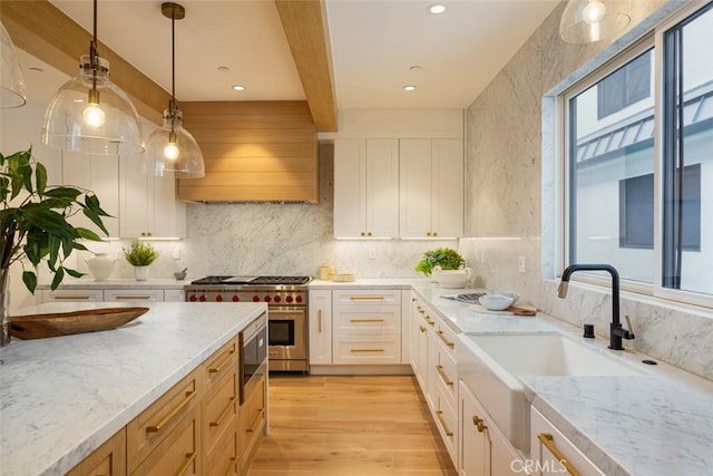 kitchen with white cabinets, a healthy amount of sunlight, and beamed ceiling