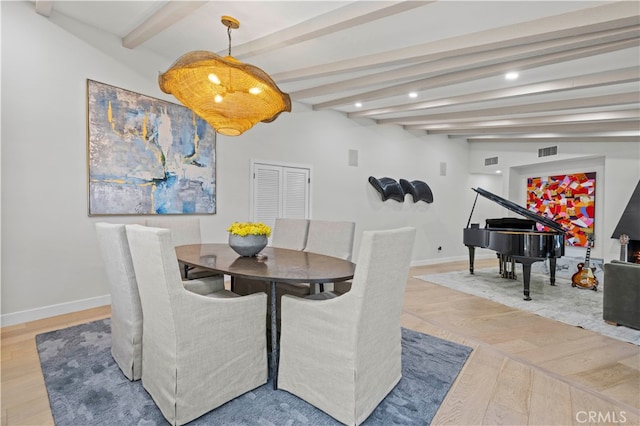 dining area featuring vaulted ceiling with beams and hardwood / wood-style flooring