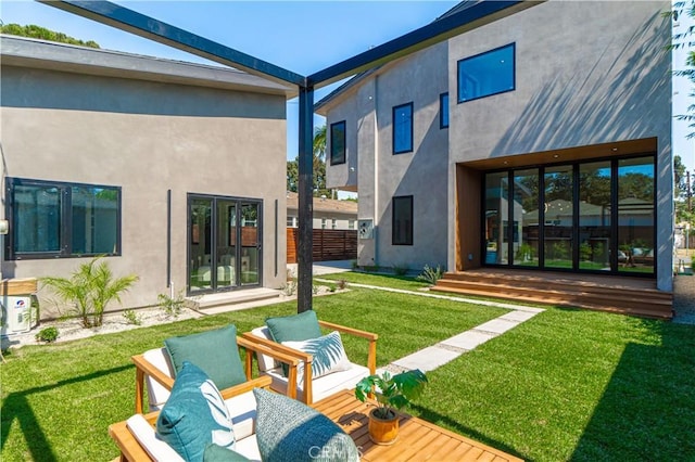 rear view of house featuring a yard