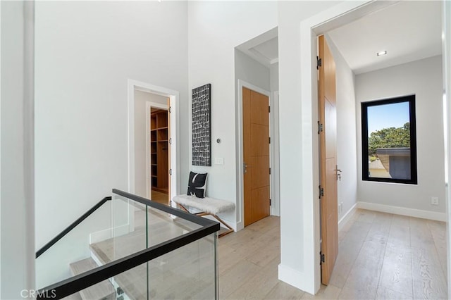 hallway with light hardwood / wood-style floors