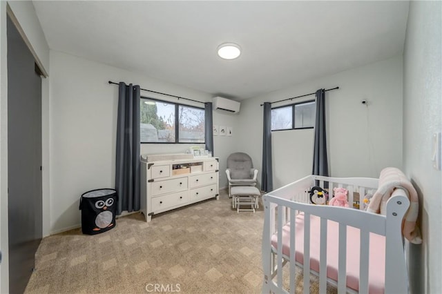 bedroom featuring an AC wall unit, a crib, a closet, and light colored carpet