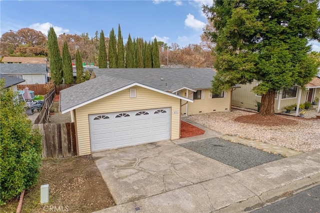 view of front of home featuring a shingled roof, fence, and driveway